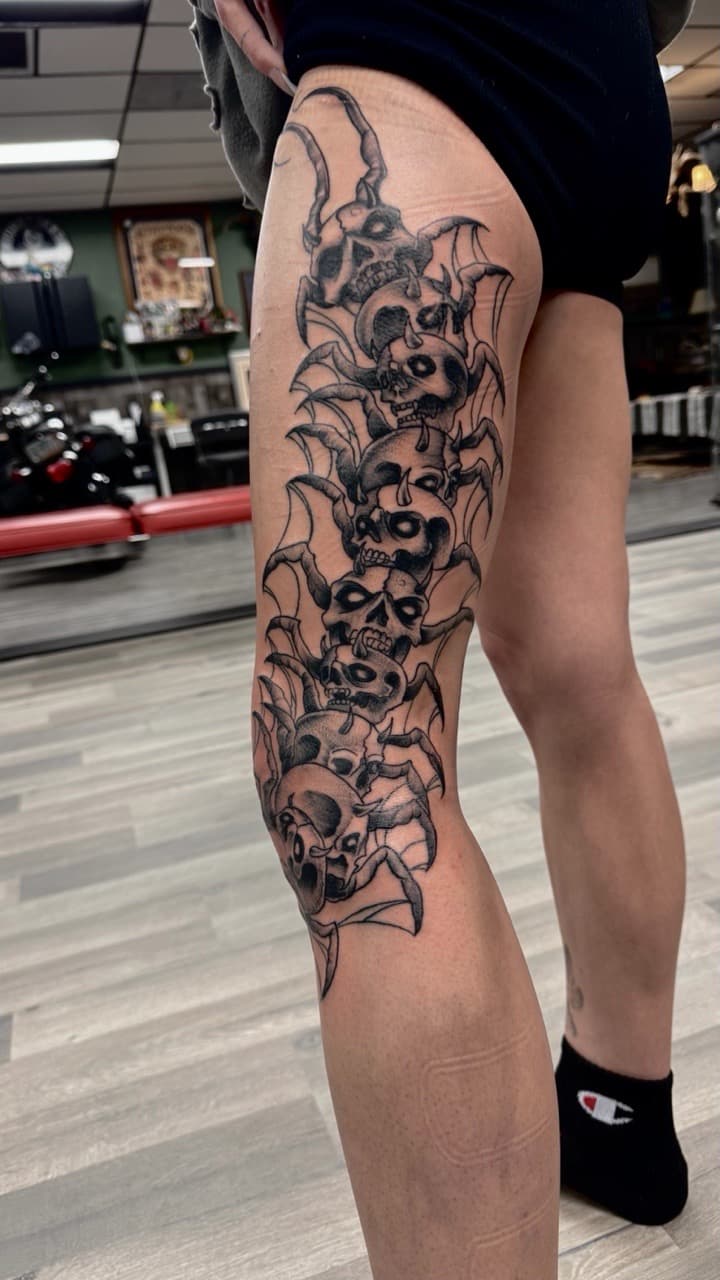 Black & Grey + Gothic skulls tattoo on Thigh by Radtattoo on TattMe