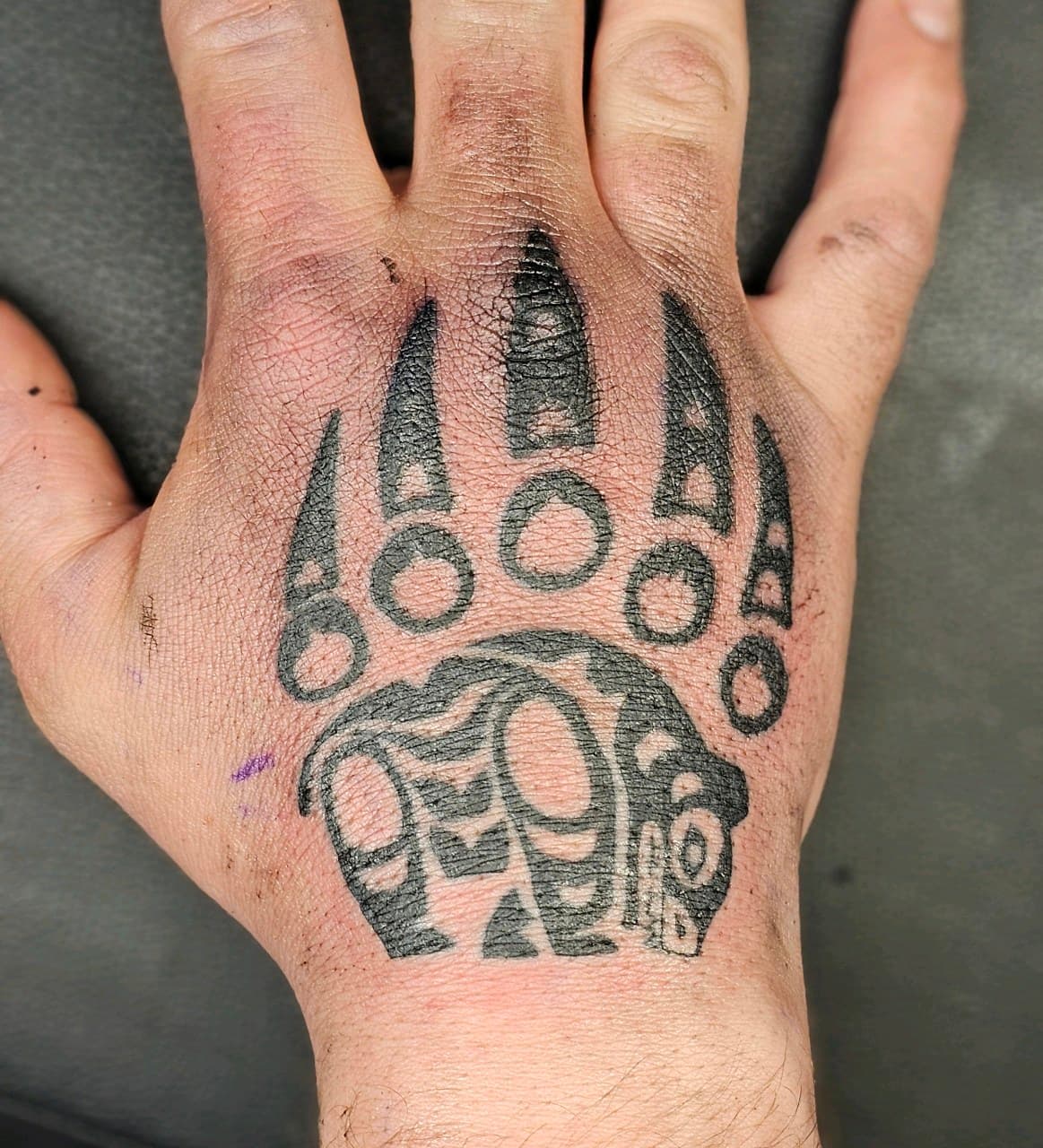 Tribal + Black-work bear paw tattoo on Hand by Selva_Tierra_Tattoos on TattMe
