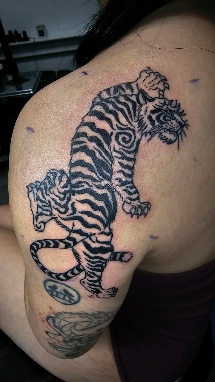 Black & Grey + Illustrative tiger tattoo on Shoulder by Selva_Tierra_Tattoos on TattMe