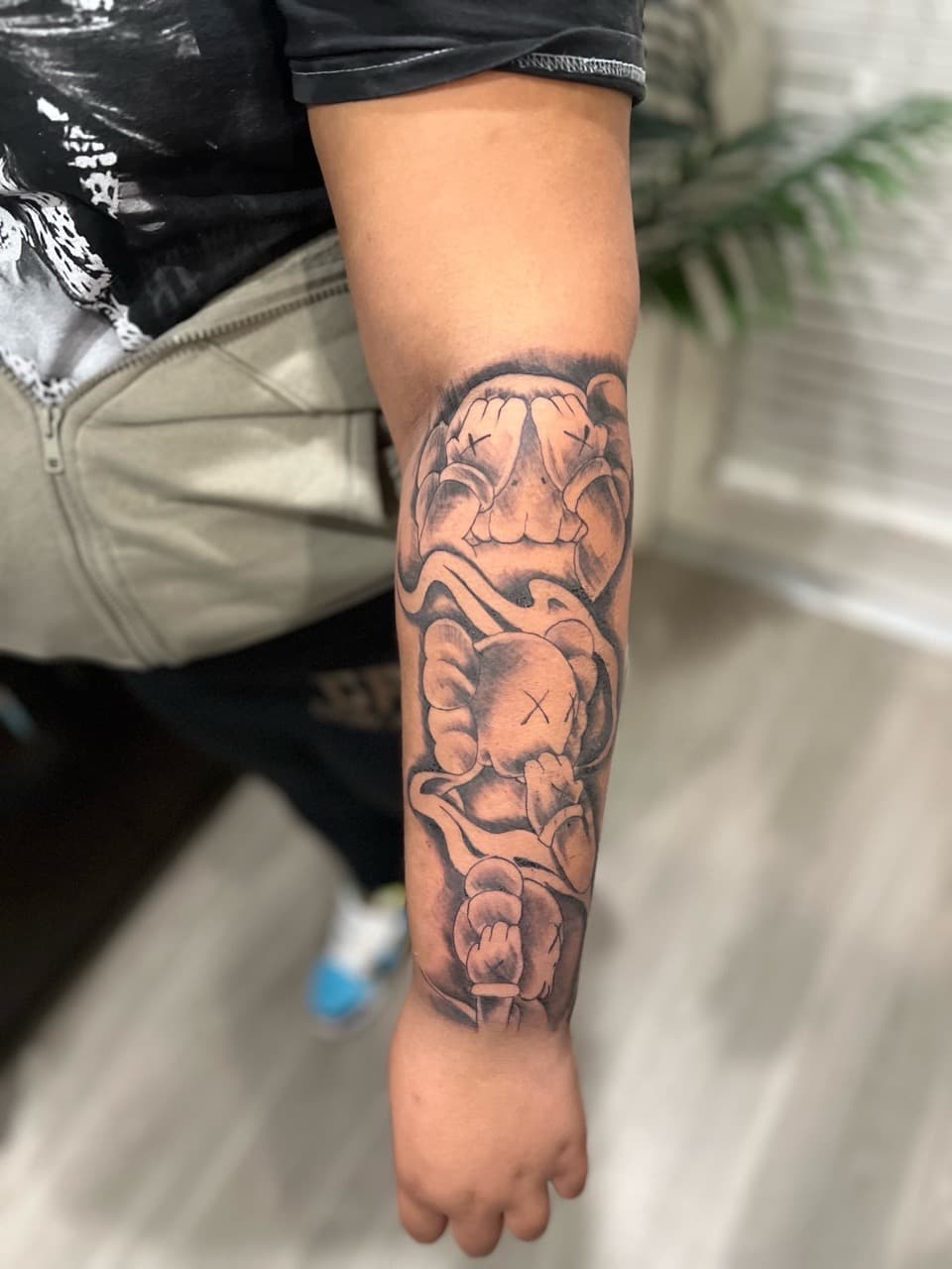 Black & Grey + Illustrative kaws tattoo on Forearm by NUDEINK on TattMe