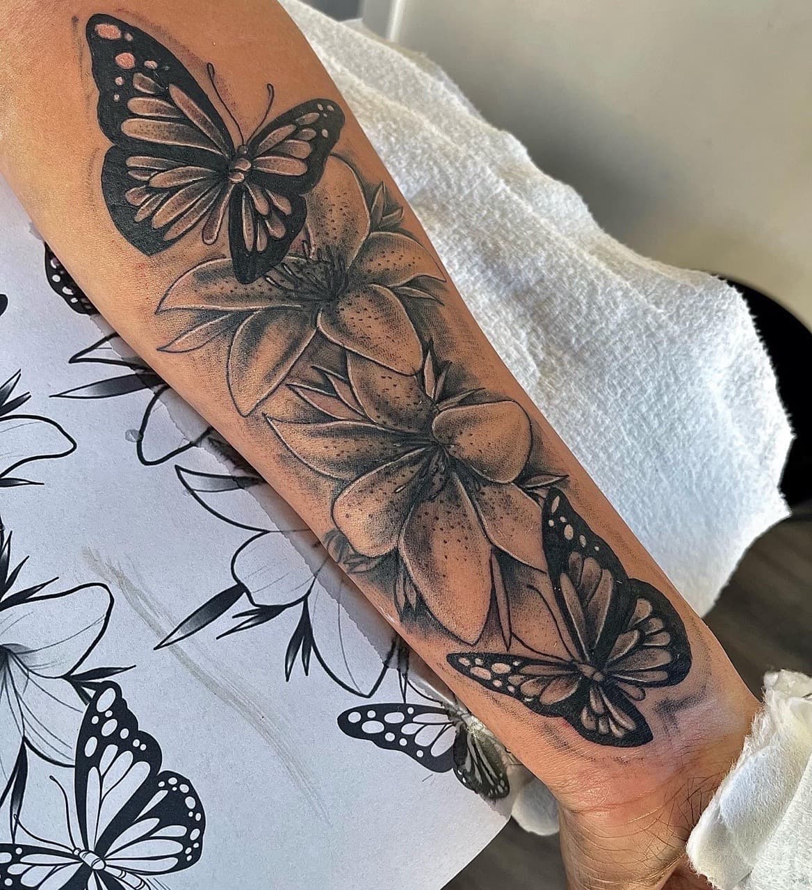 Black & Grey + Floral butterflies tattoo on Forearm by NUDEINK on TattMe