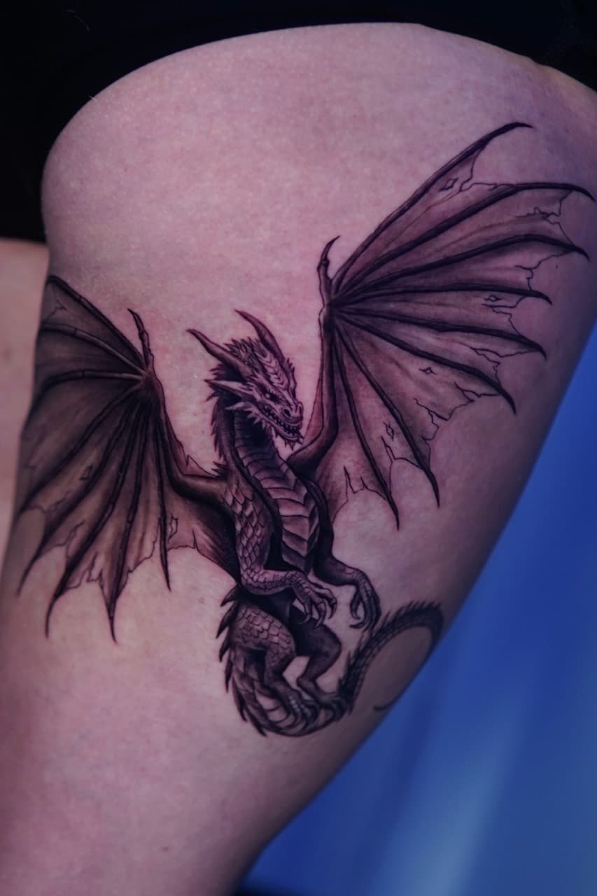 Black & Grey + Illustrative dragon tattoo on Thigh by Moe_Tatts on TattMe