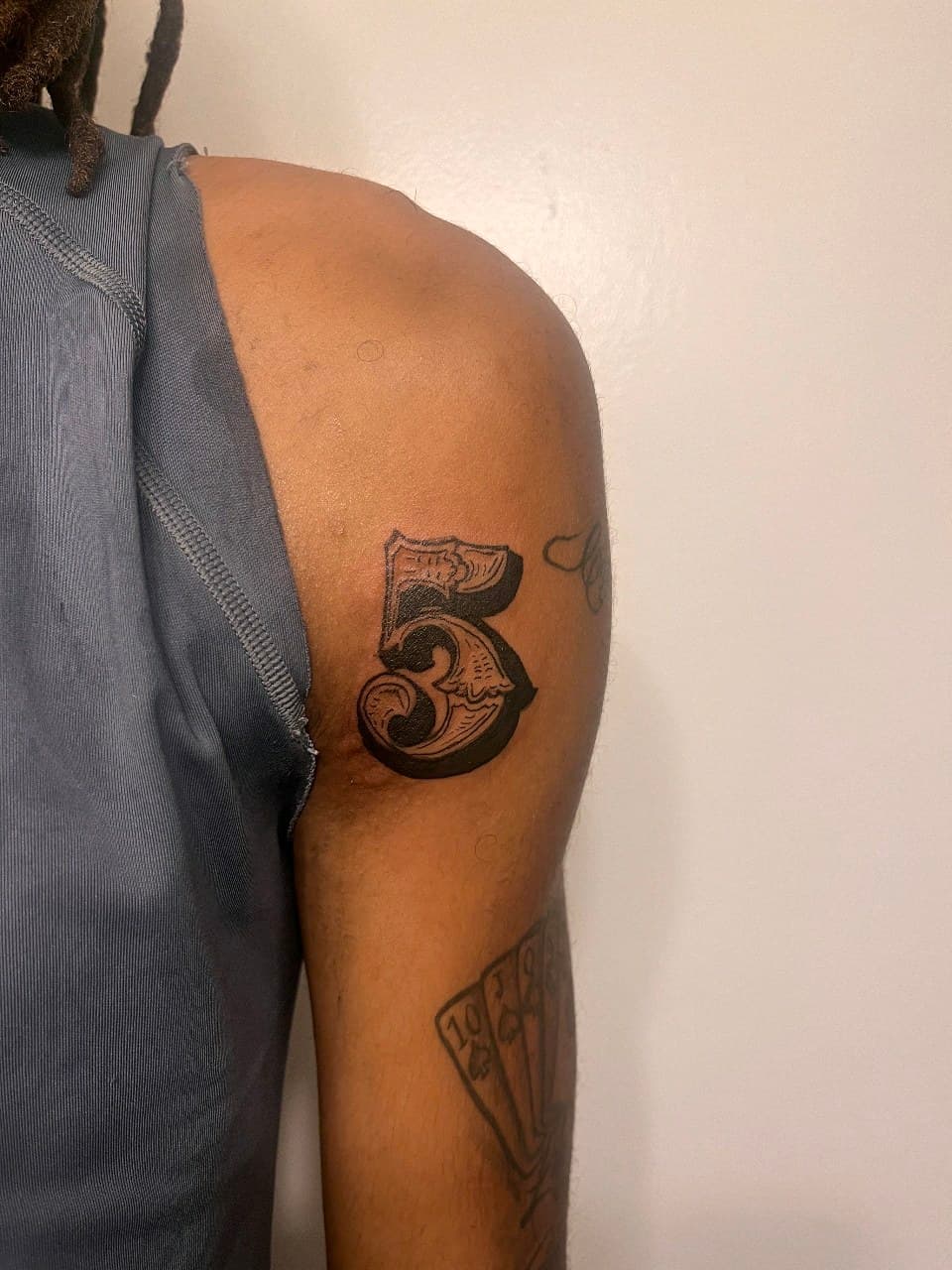 Black-work + Neo-Traditional number tattoo on Upper Arm by Cay_Tattoos on TattMe