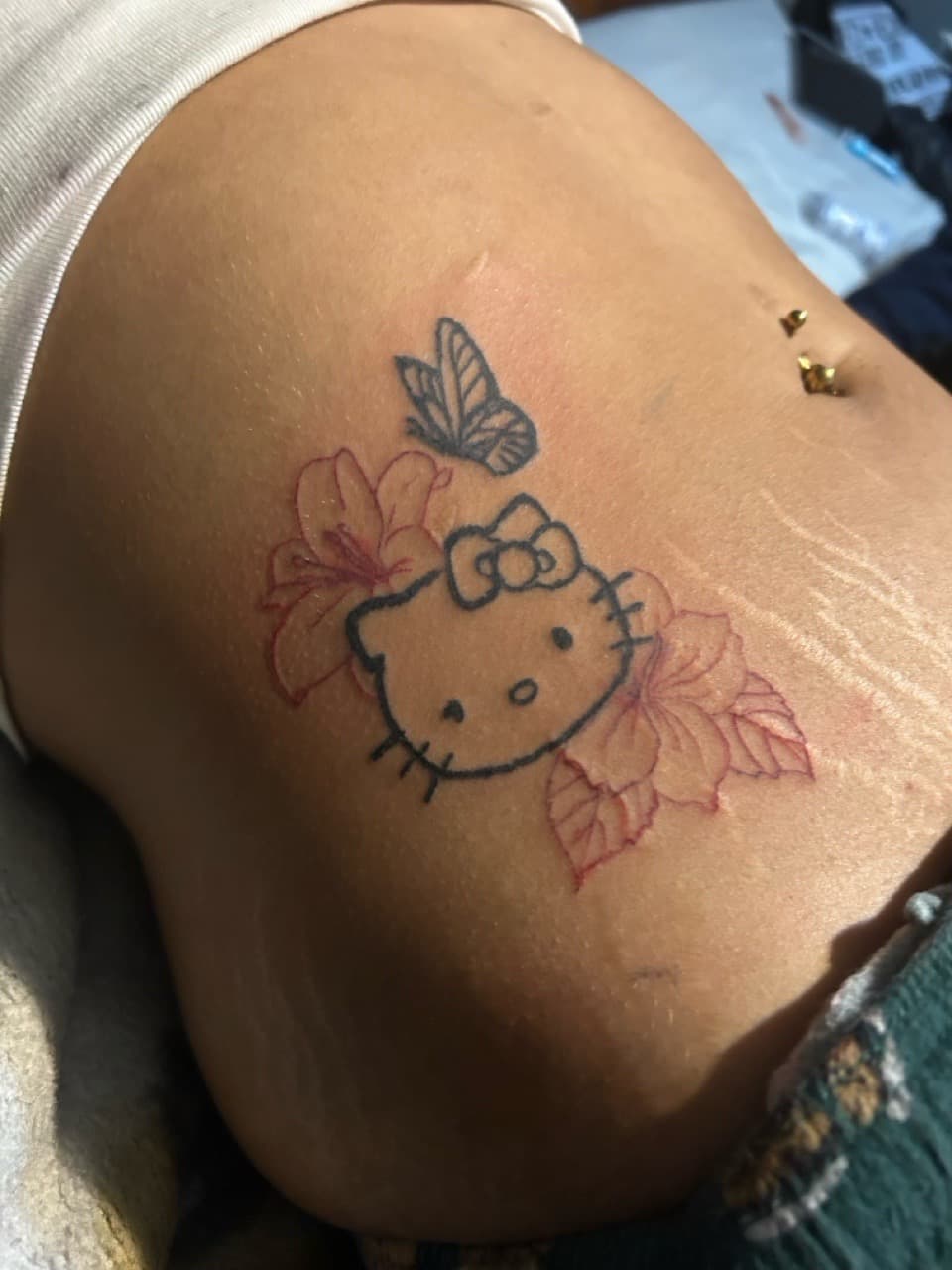Line-work + Black-work hello kitty tattoo on Ribs by inkbynyyair on TattMe