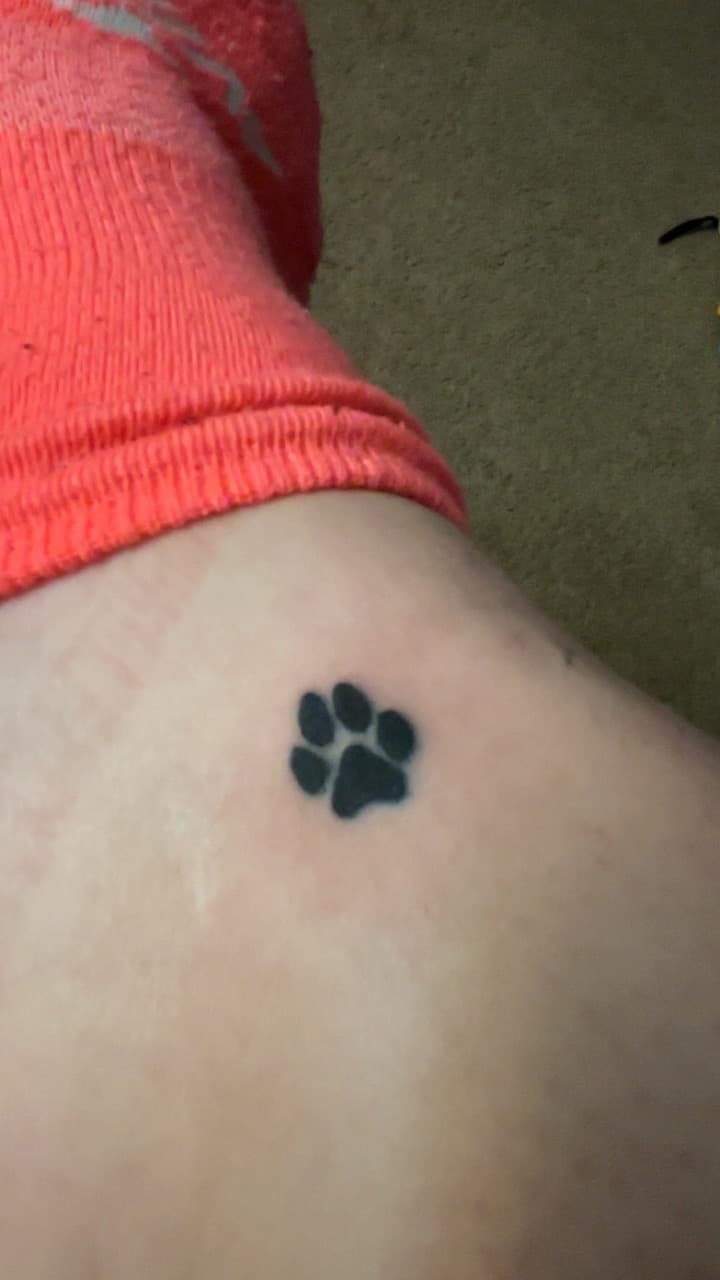 Black-work + Minimalist paw print tattoo on Thigh by addiesinkwork on TattMe