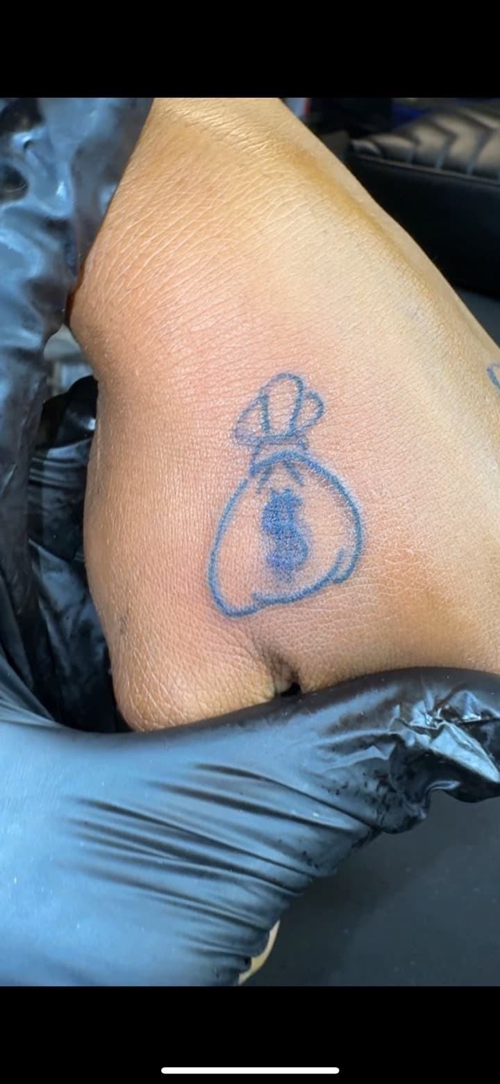Fine Line + Line-work money bag tattoo on Hand by InkByArtie on TattMe