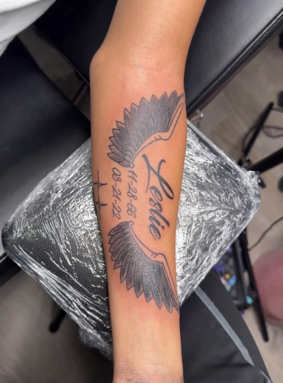 Black & Grey + Lettering wings tattoo on Forearm by InkByArtie on TattMe