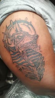 Black & Grey + Illustrative wolf tattoo on Upper Arm by Cakes_Ariana on TattMe