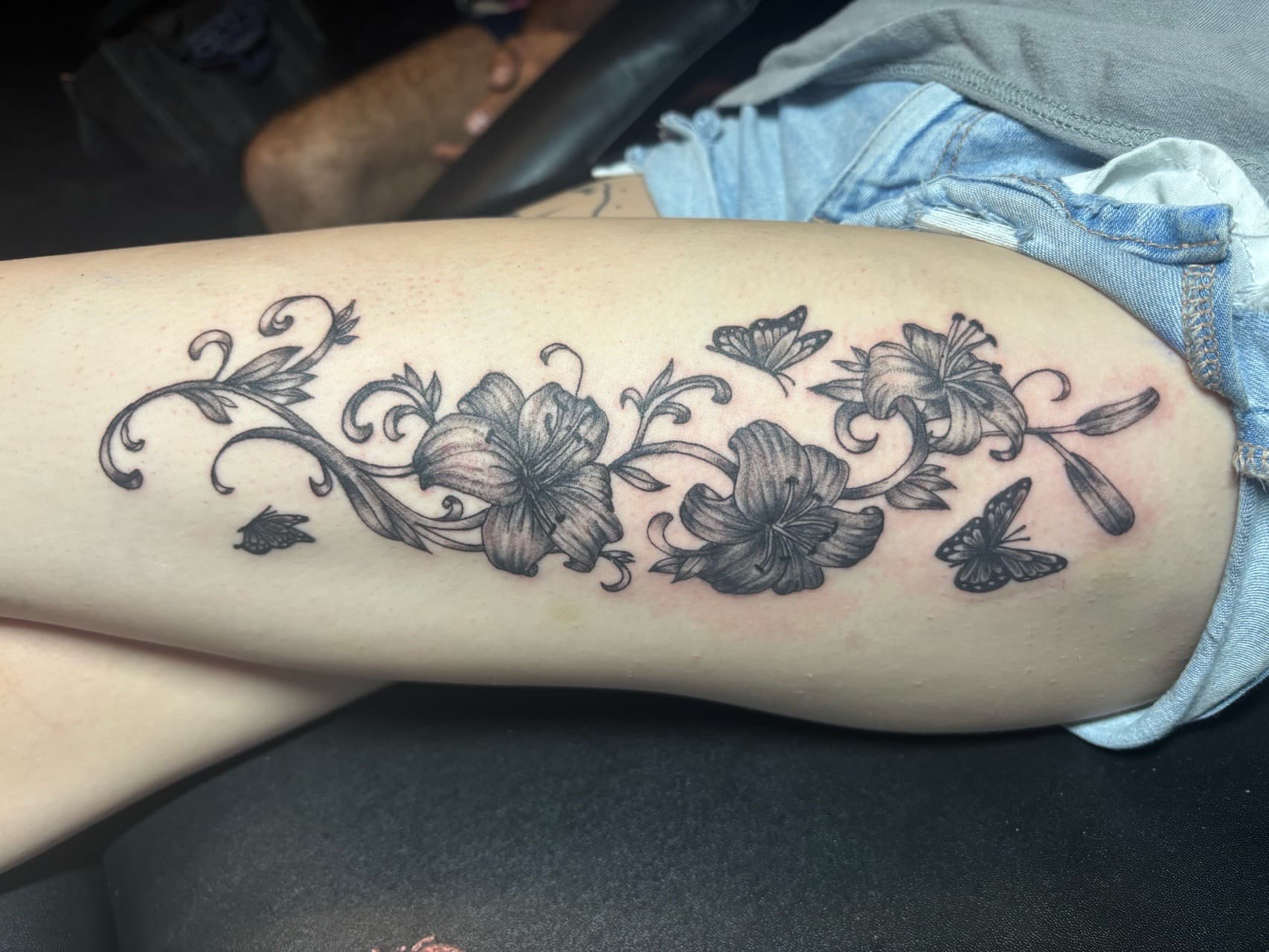 Black & Grey + Floral flowers tattoo on Thigh by TattedbyJayden on TattMe