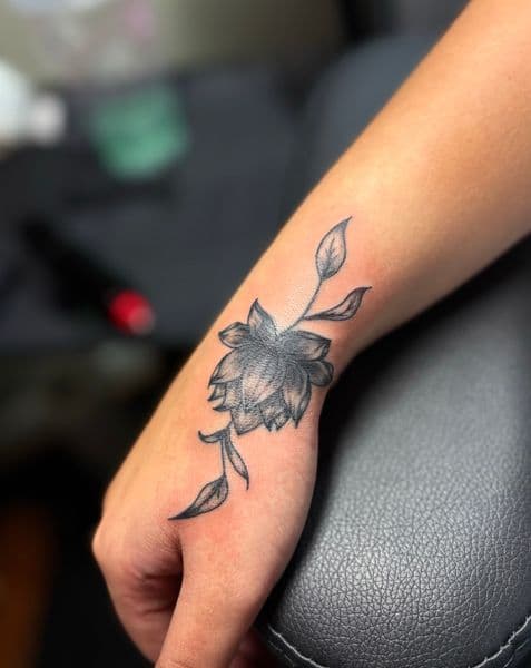 Black & Grey + Fine Line flower tattoo on Hand by TattedbyJayden on TattMe