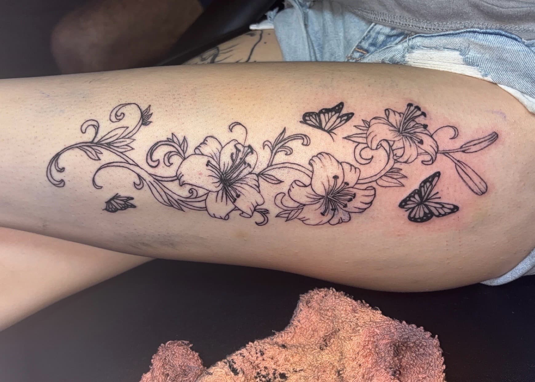 Floral + Fine Line flowers tattoo on Thigh by TattedbyJayden on TattMe