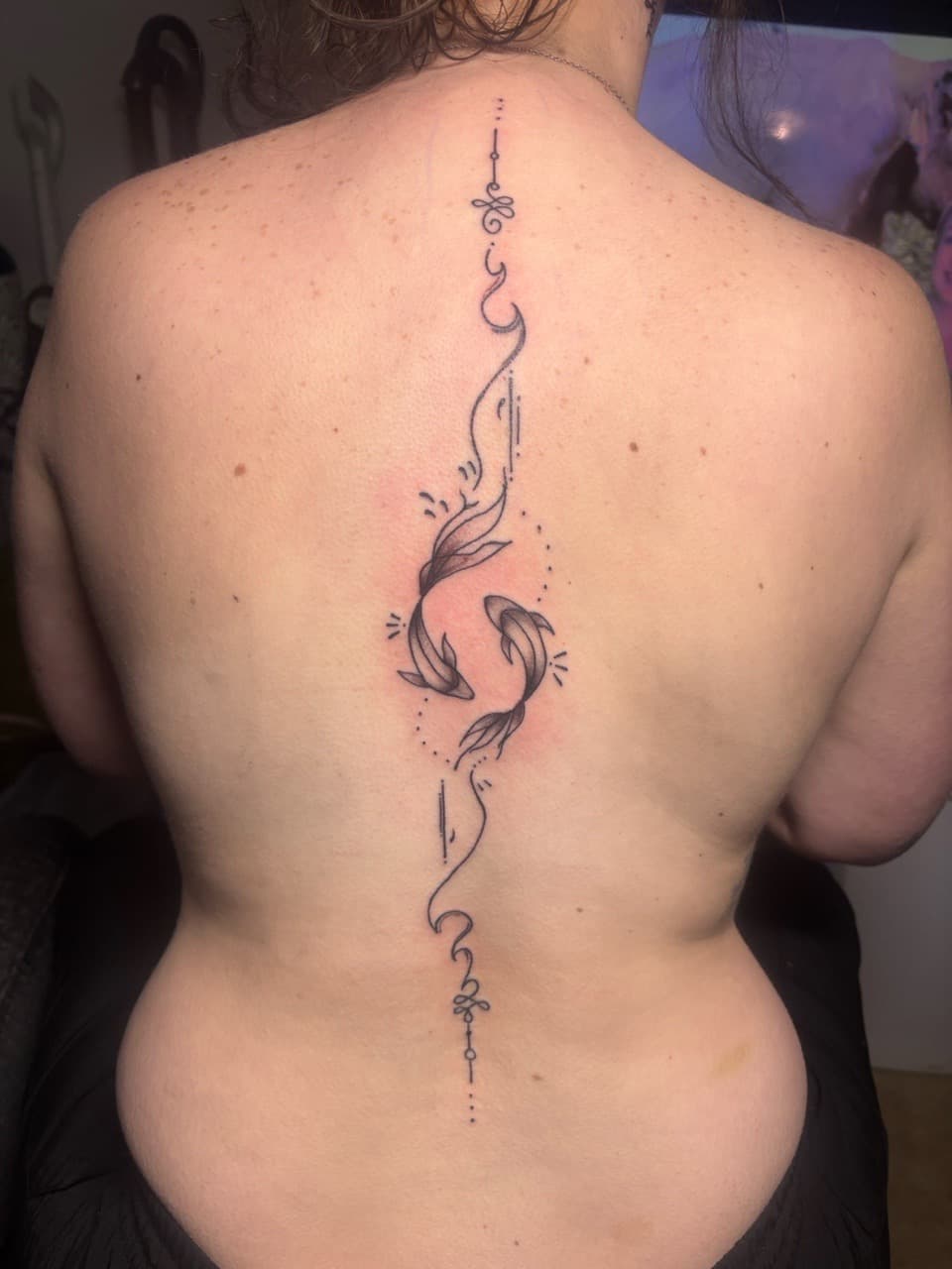 Fine Line + Black-work fish tattoo on Upper Back by TattedbyJayden on TattMe