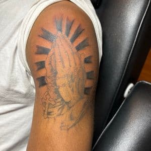 Black & Grey + Religious praying hands tattoo on Upper Arm by TattedbyJayden on TattMe