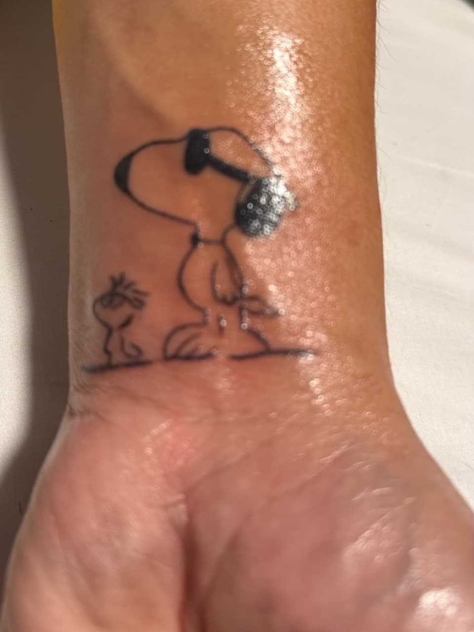 Fine Line + Minimalist snoopy tattoo on Wrist by Tattedbykai on TattMe