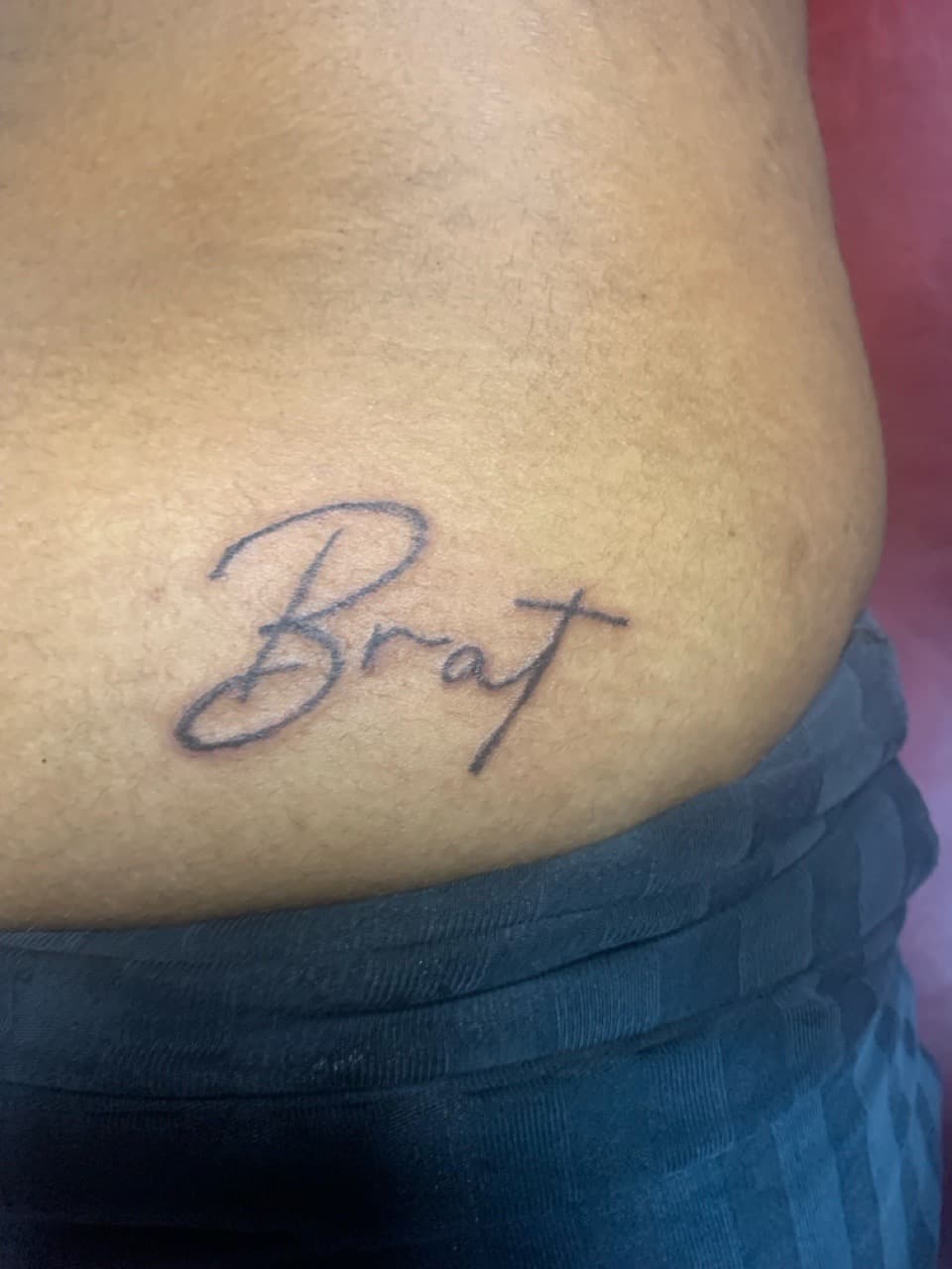 Lettering + Script brat tattoo on Lower Back by Braedan_Sterling on TattMe