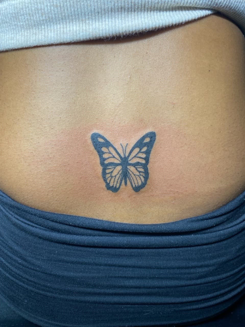 Black-work + Minimalist butterfly tattoo on Lower Back by Fishscale_Images on TattMe