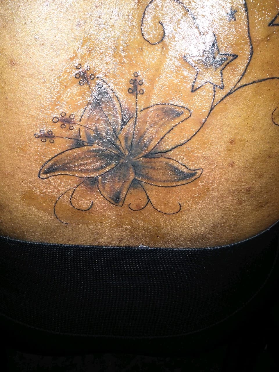 Floral + Black & Grey flower tattoo on Lower Back by TattmanW on TattMe
