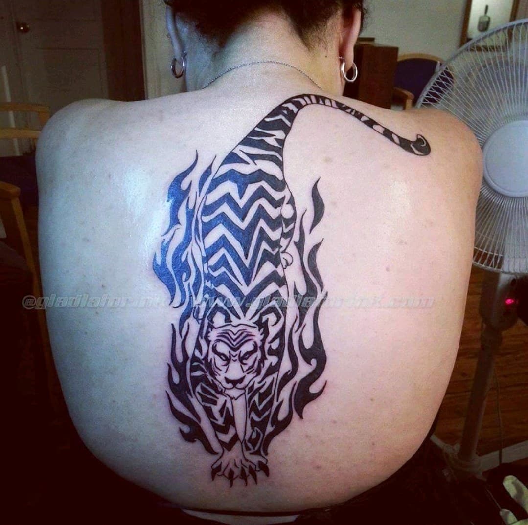 Tribal + Black-work tiger tattoo on Upper Back by Dank_N_Paint on TattMe
