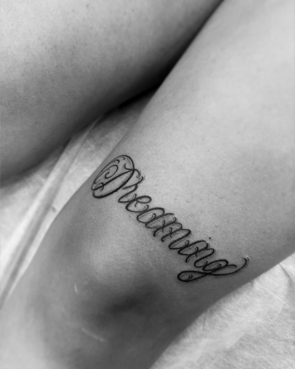 Lettering + Script dreaming tattoo on Thigh by AidanTattoos on TattMe