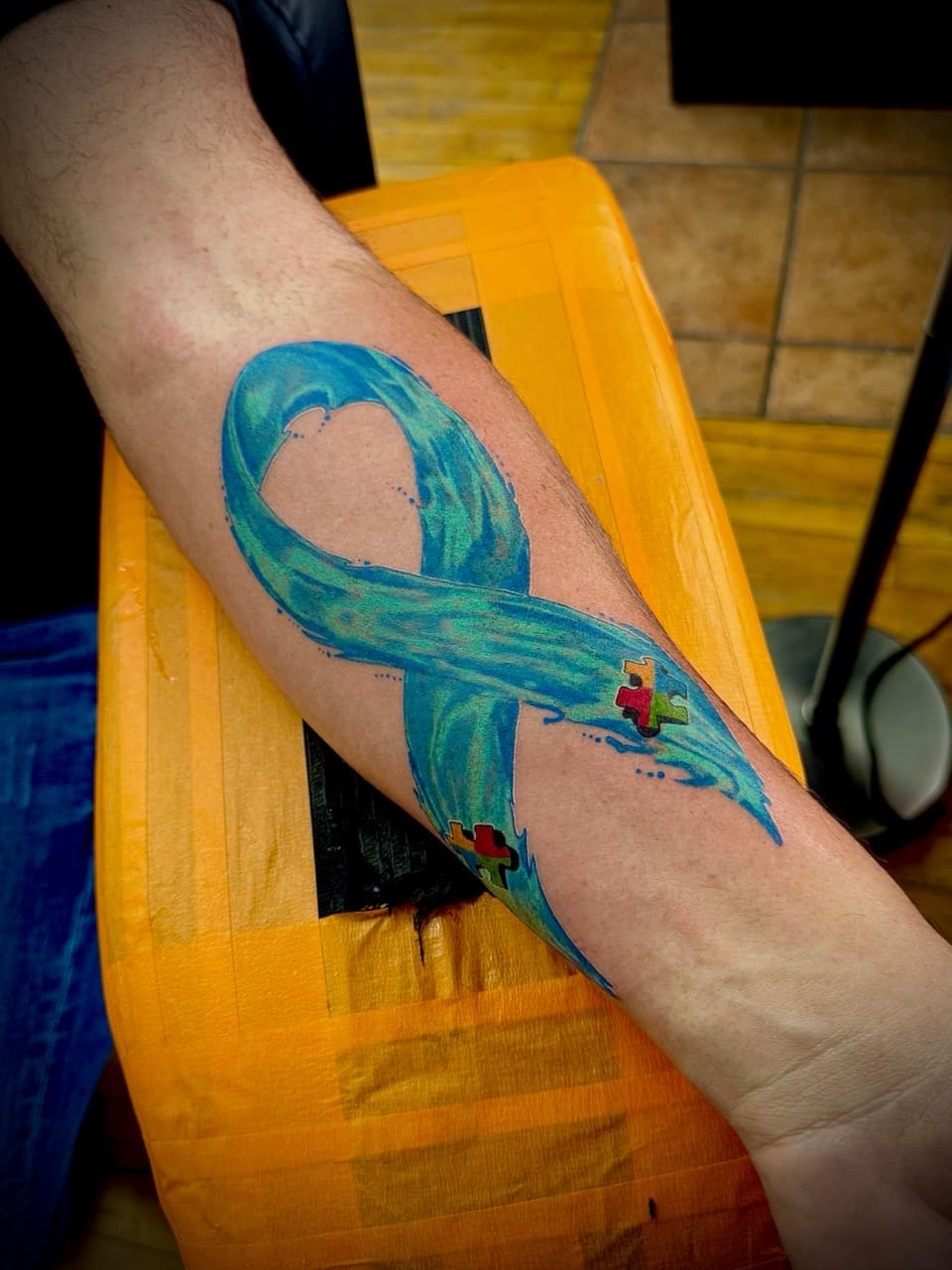 Watercolor + Color autism awareness tattoo on Forearm by William_Samaras on TattMe