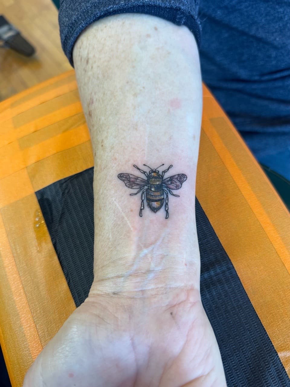 Fine Line + Color bee tattoo on Wrist by William_Samaras on TattMe
