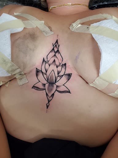 Black & Grey + Illustrative lotus tattoo on Sternum by William_Samaras on TattMe