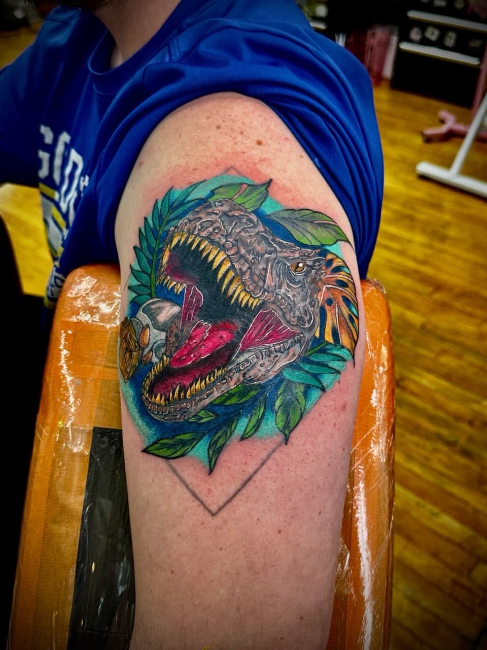 Illustrative + Color dinosaur tattoo on Upper Arm by William_Samaras on TattMe