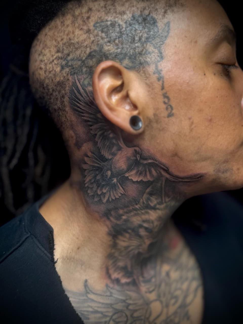 Black & Grey + Illustrative bird tattoo on Neck (Side) by Juggin_Ink_Studios on TattMe