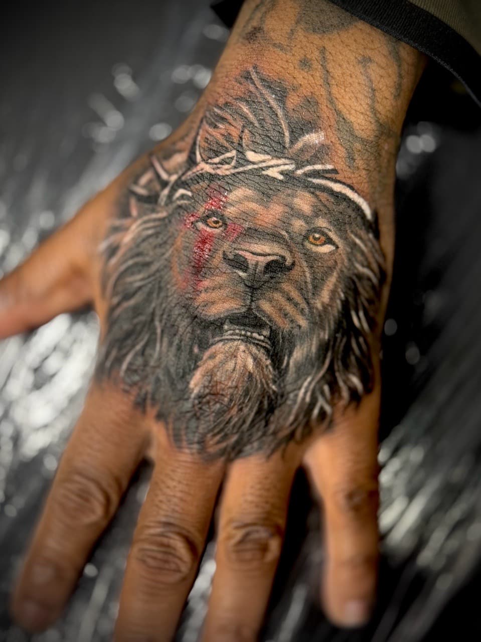 Realism + Black & Grey lion tattoo on Hand by Juggin_Ink_Studios on TattMe