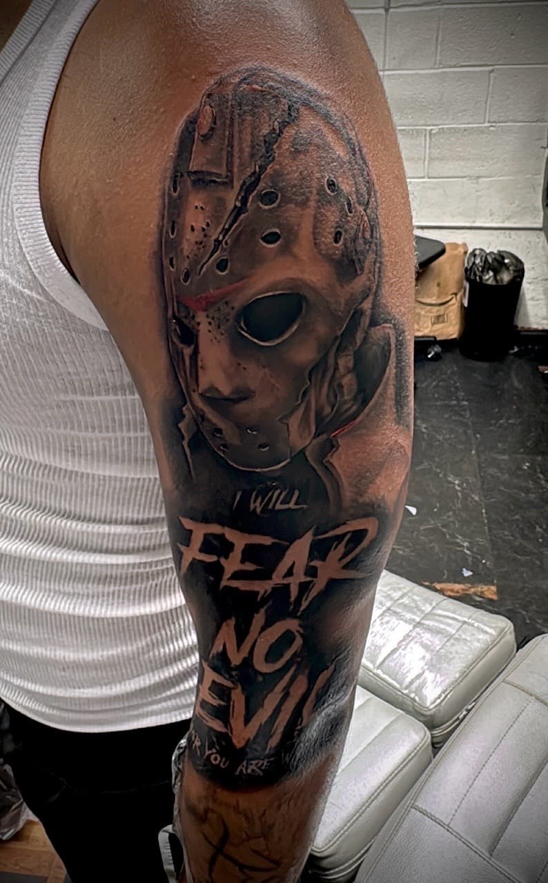 Realism + Black & Grey jason mask tattoo on Upper Arm by Juggin_Ink_Studios on TattMe