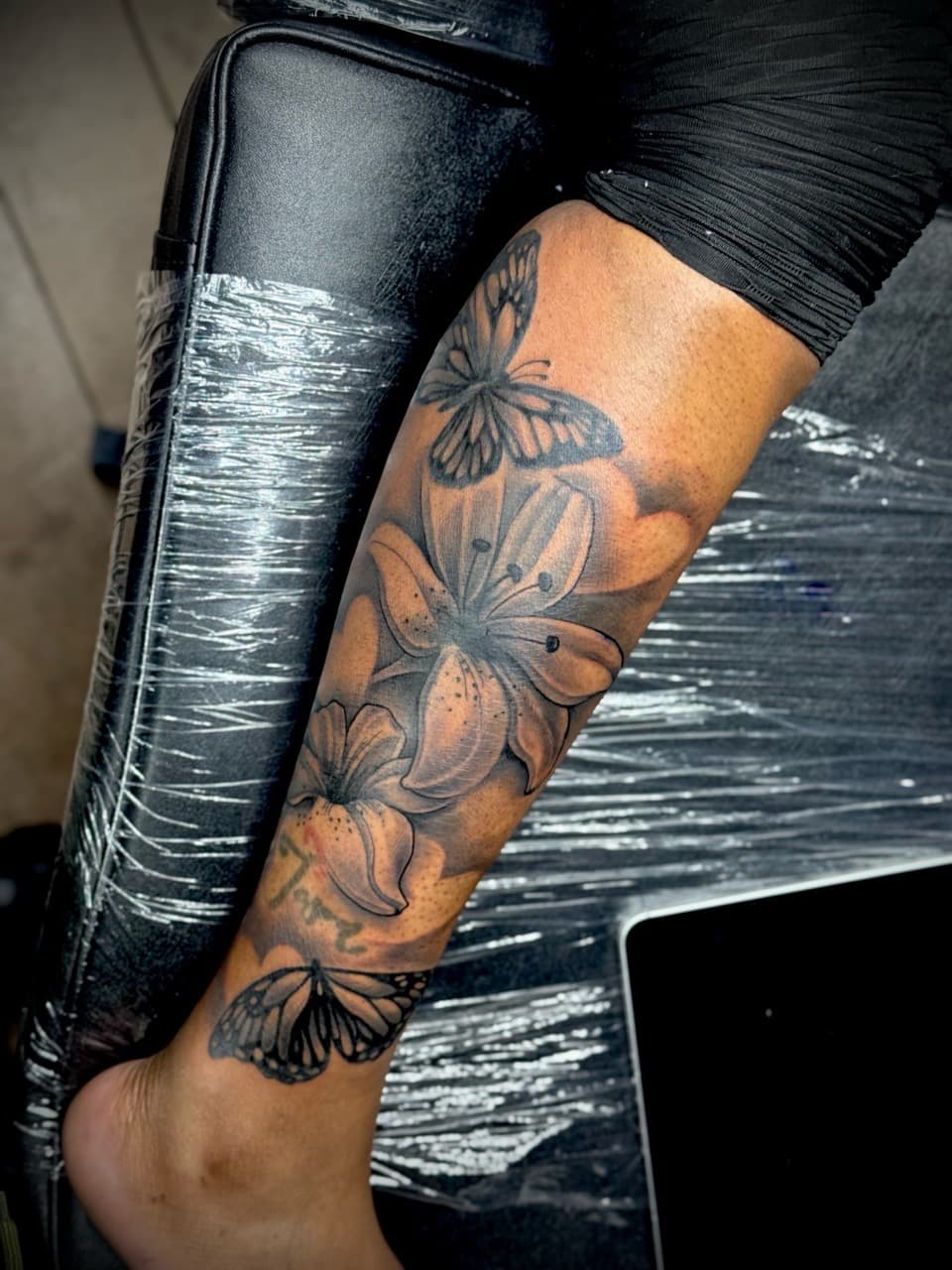 Black & Grey + Floral butterflies tattoo on Calf by Juggin_Ink_Studios on TattMe