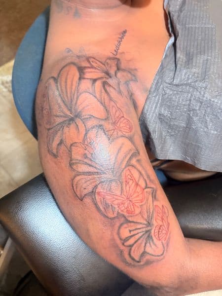 Fine Line + Floral lilies tattoo on Upper Arm by inkedbyleekk on TattMe