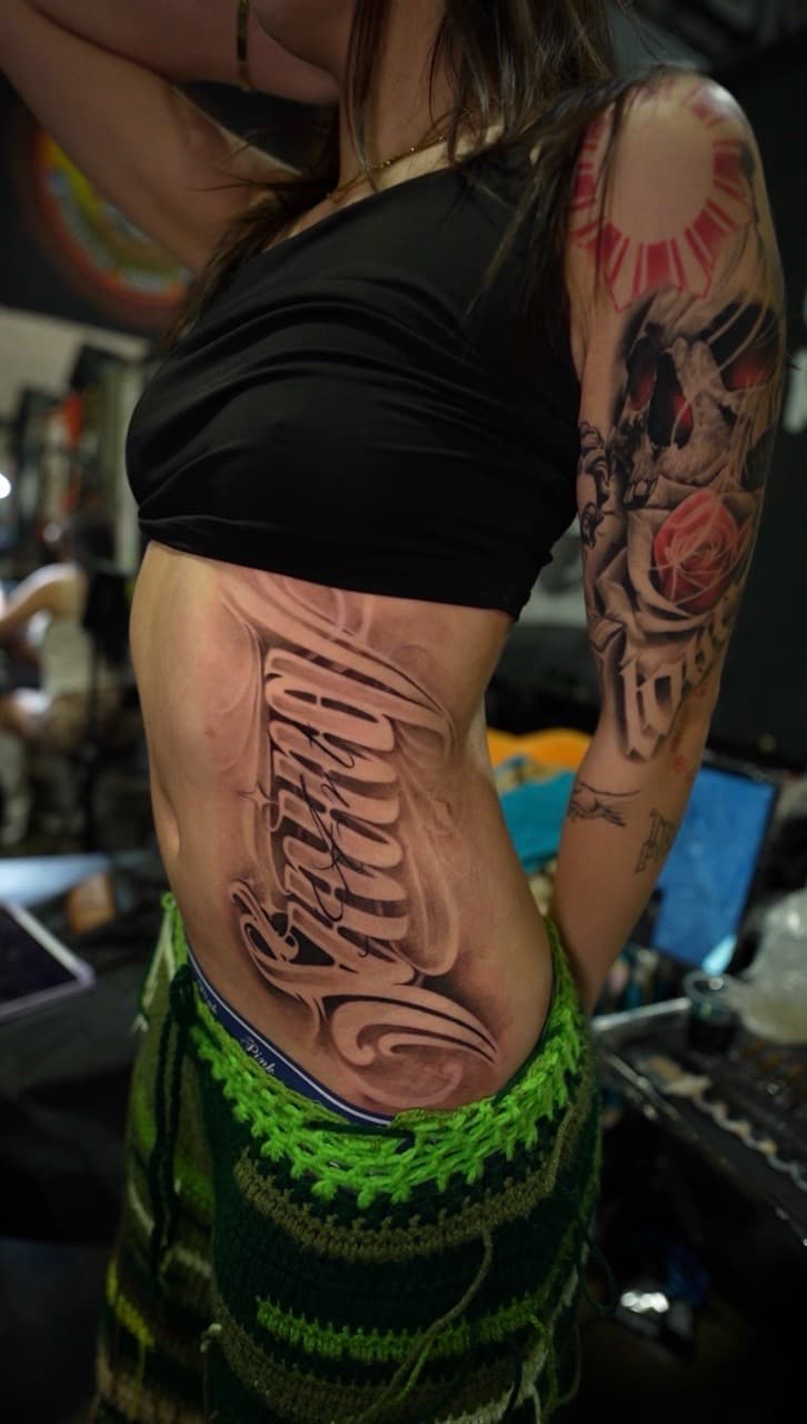 Lettering + Script skull tattoo on Ribs by Satchmoe_Art on TattMe