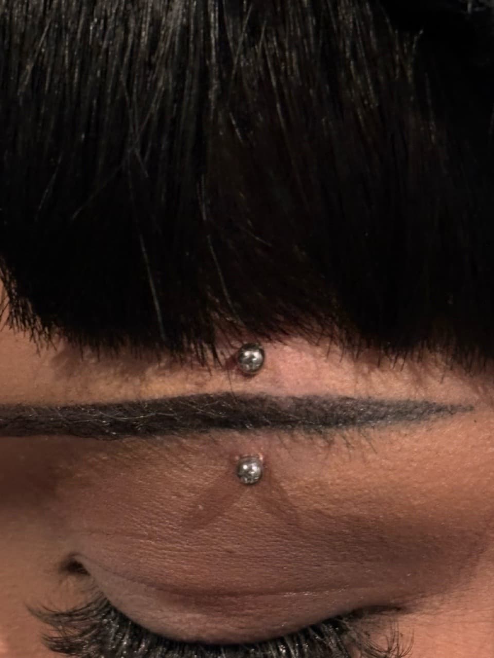 Minimalist + Line-work piercings tattoo on Forehead by ArtIsTatts on TattMe