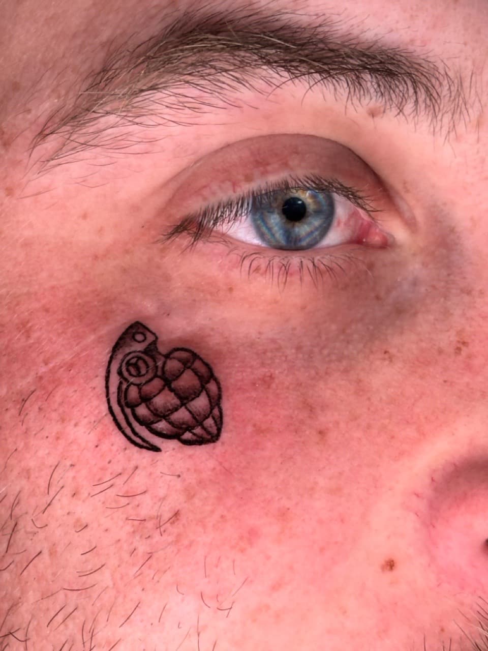 Black-work + Illustrative grenade tattoo on Face by ArtIsTatts on TattMe