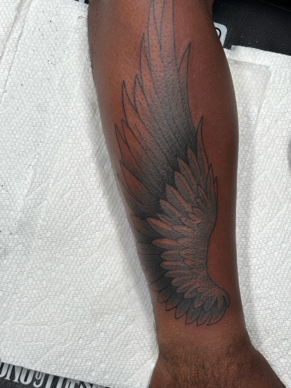 Black & Grey + Illustrative wing tattoo on Forearm by Ink_Mob_Studios on TattMe