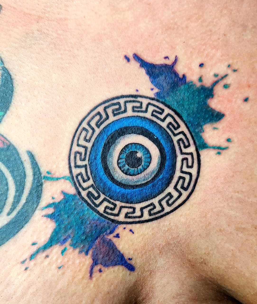 Geometric + Color evil eye tattoo on Shoulder Blade by Inkytat2z on TattMe