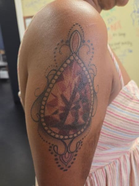 Color + Black-work gemstone tattoo on Upper Arm by 2nd_Circle_Tattoo_Co on TattMe
