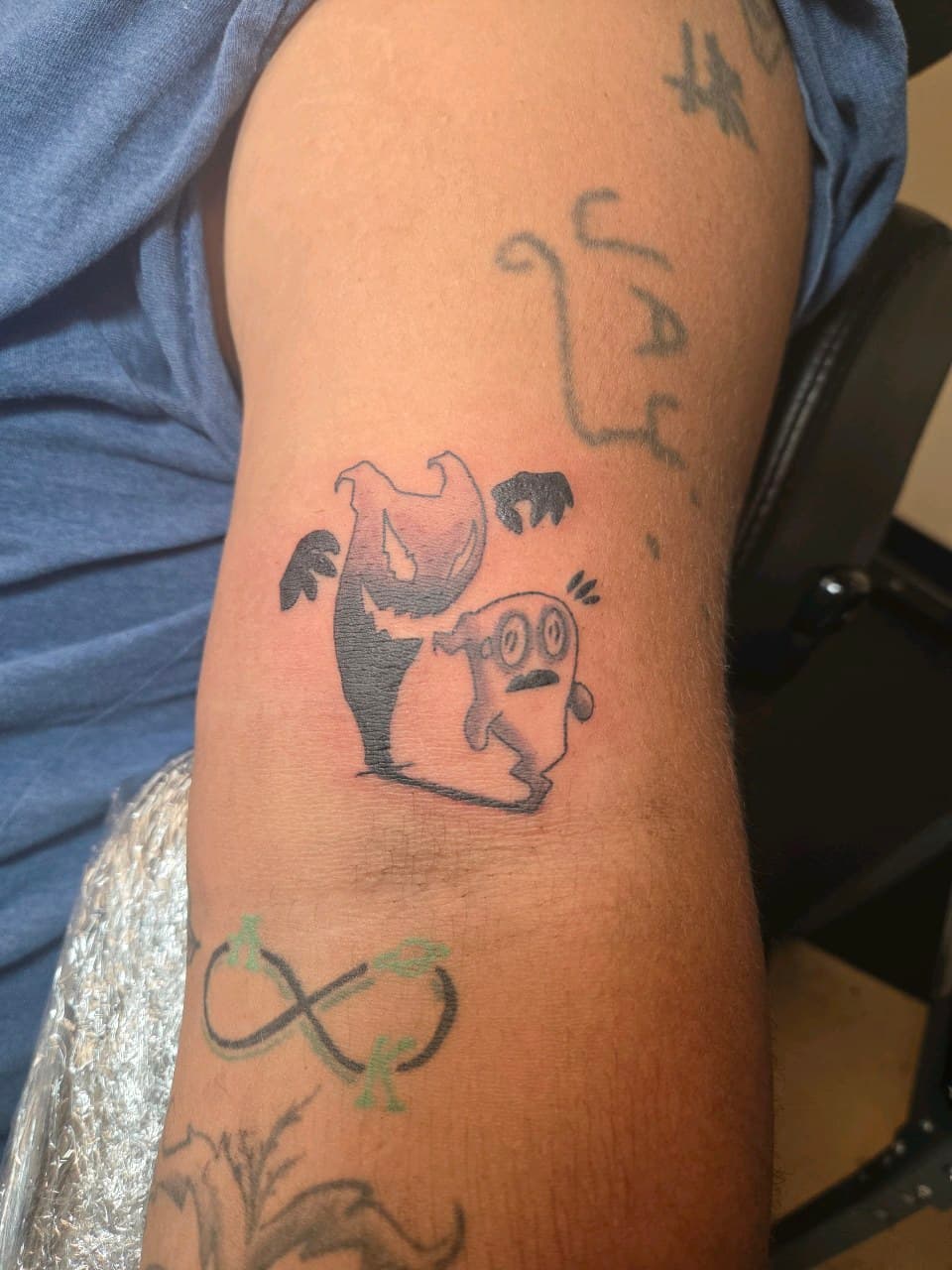 Cartoon + Black-work ghosts tattoo on Upper Arm by 2nd_Circle_Tattoo_Co on TattMe