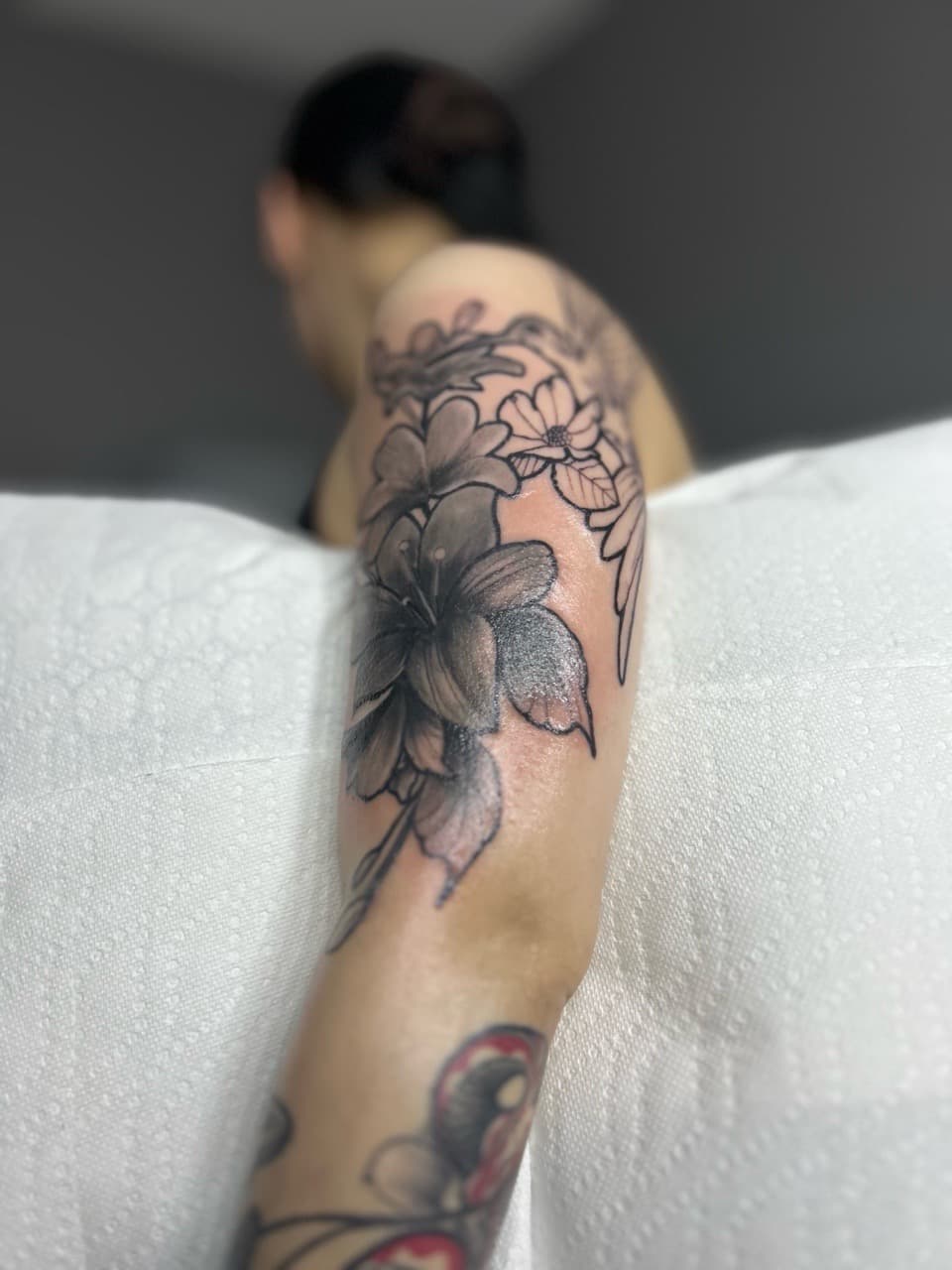 Floral + Black & Grey flowers tattoo on Upper Arm by 32_Incc_STUDIOS_LLC. on TattMe