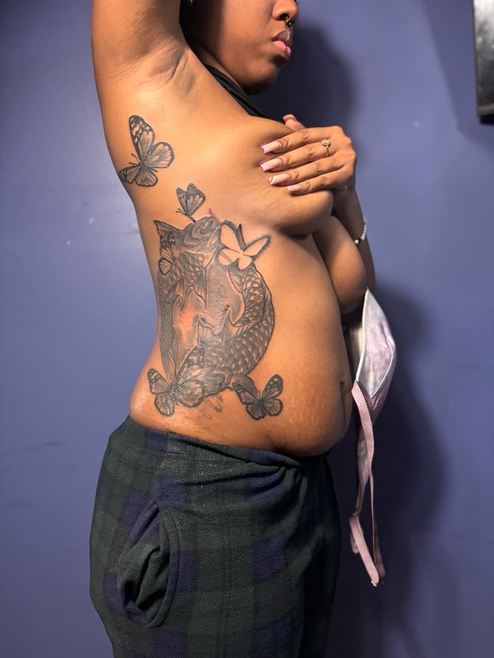 Black & Grey + Illustrative koi fish tattoo on Ribs by 32_Incc_STUDIOS_LLC. on TattMe