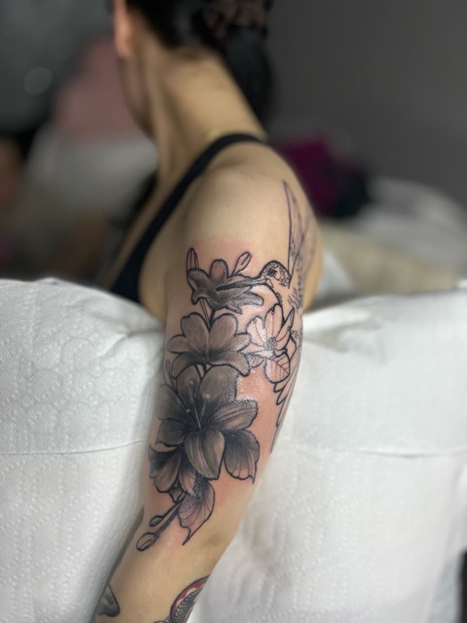 Black & Grey + Floral hummingbird tattoo on Upper Arm by 32_Incc_STUDIOS_LLC. on TattMe