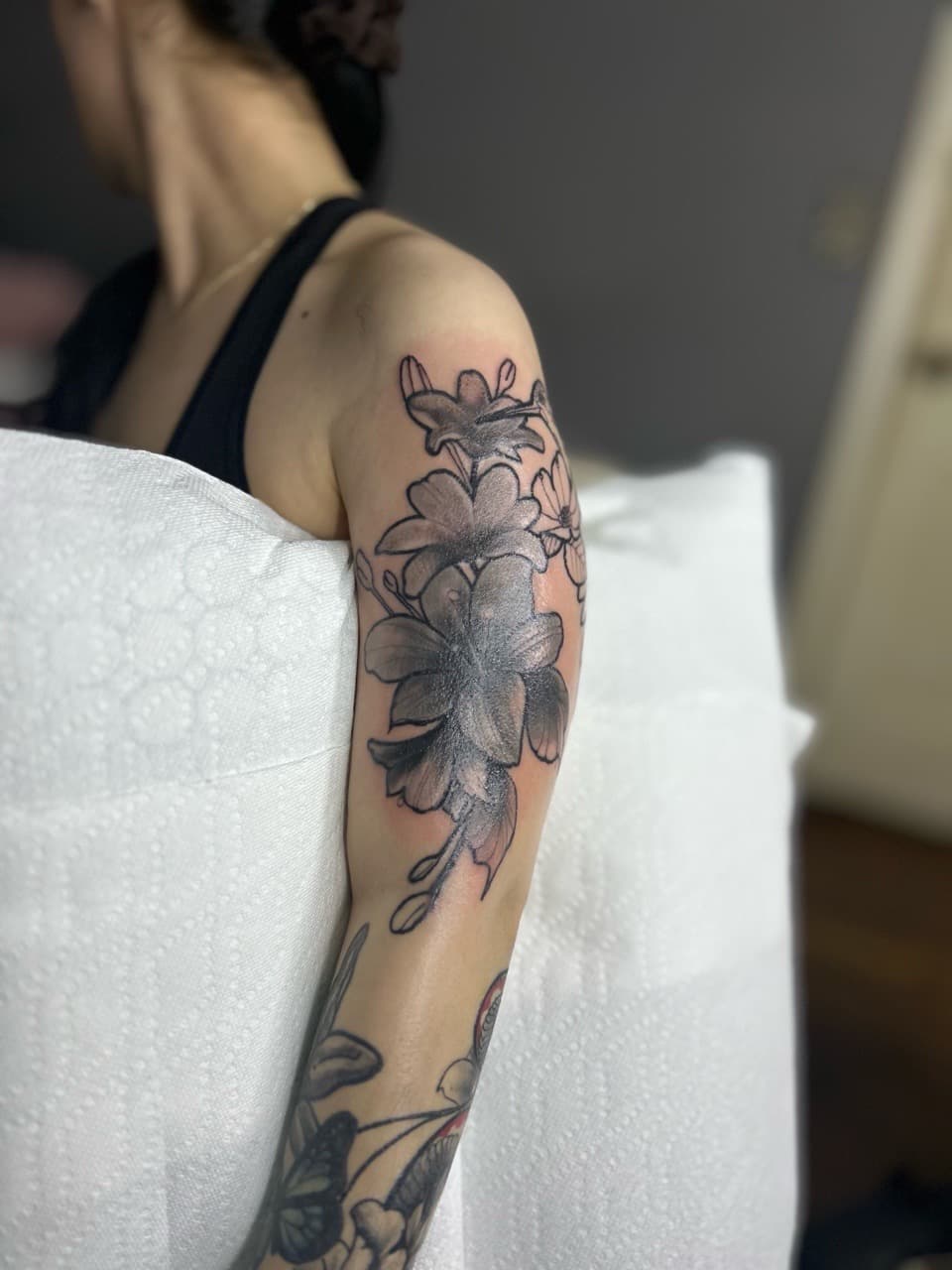 Floral + Black & Grey flowers tattoo on Upper Arm by 32_Incc_STUDIOS_LLC. on TattMe