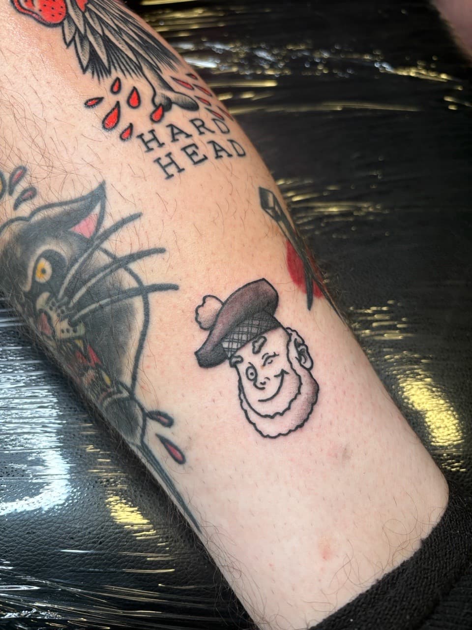 Traditional + American Traditional winking face tattoo on Calf by Brogan_Tattoos on TattMe