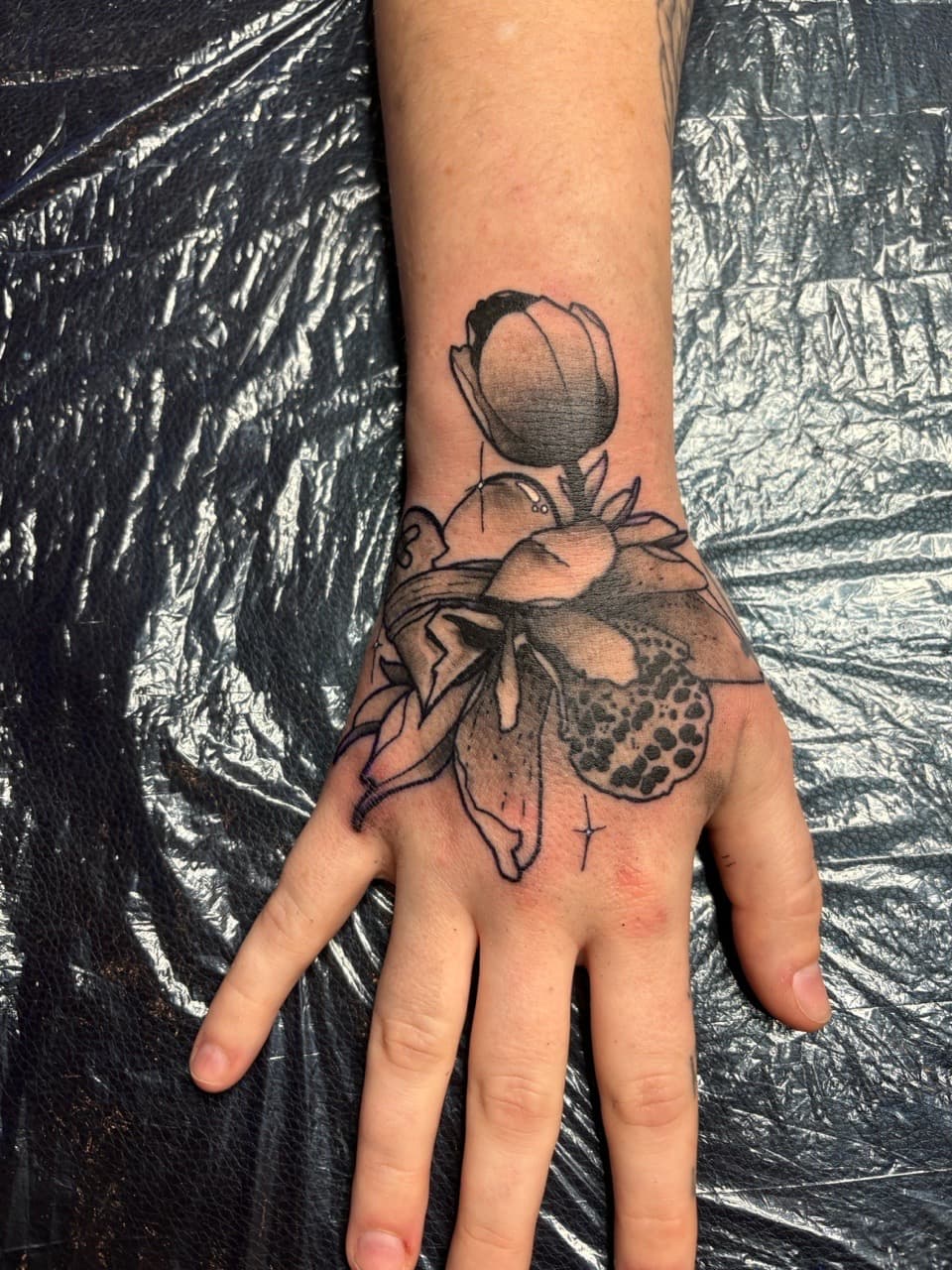 Black & Grey + Dot-work flowers tattoo on Hand by Brogan_Tattoos on TattMe