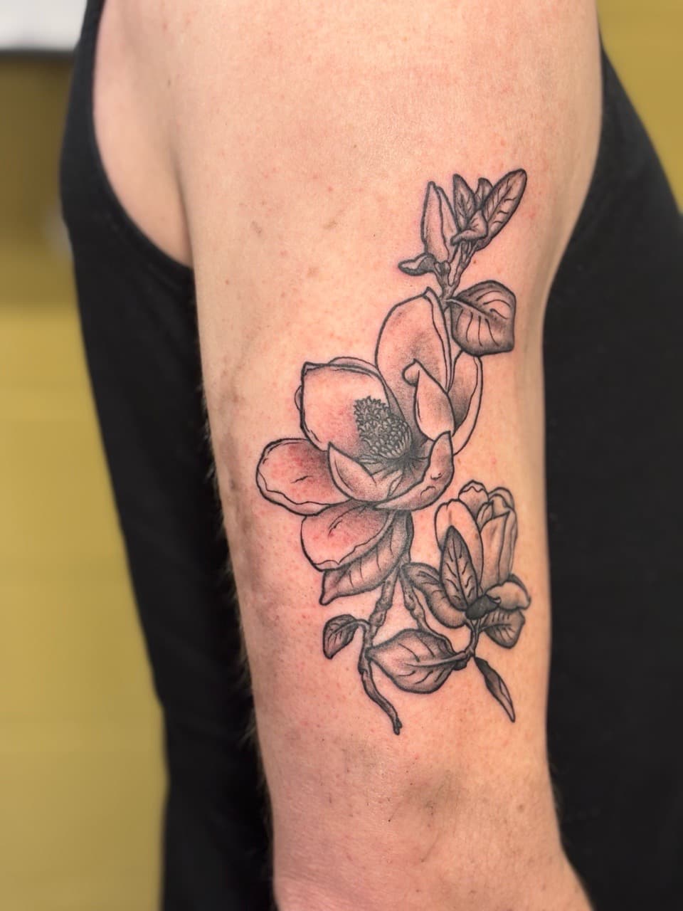 Floral + Black & Grey magnolia tattoo on Upper Arm by Brogan_Tattoos on TattMe