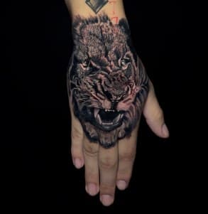 Realism + Black & Grey lion tattoo on Hand by Leway_Tattoos on TattMe