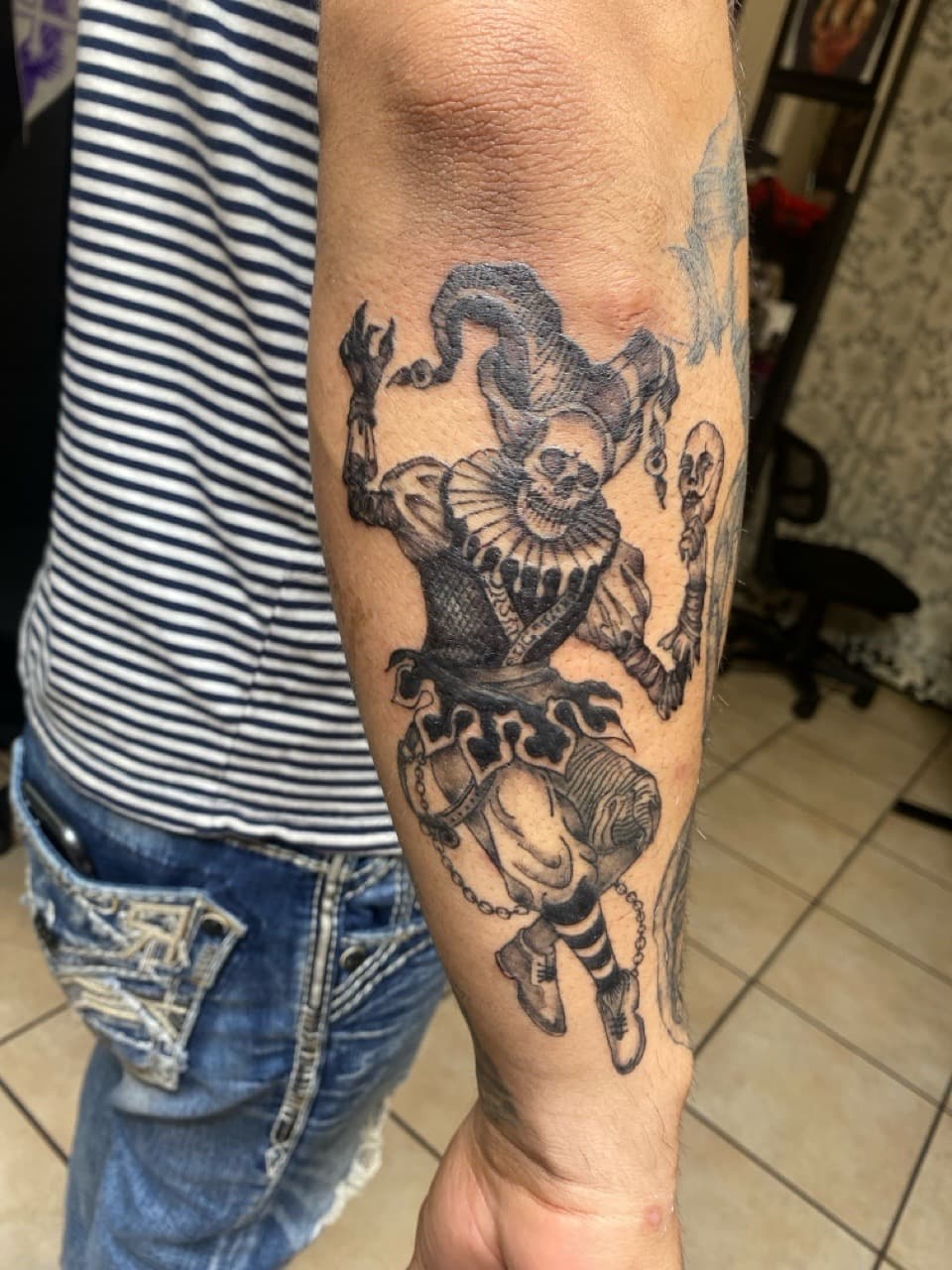 Black & Grey + Illustrative jester tattoo on Forearm by Pretty_In_Ink on TattMe