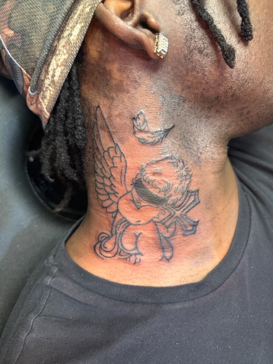 Line-work + Black-work cherub tattoo on Neck (Side) by TattedByEjai on TattMe