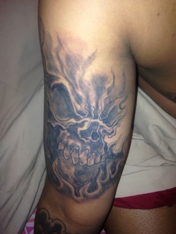 Black & Grey + Illustrative skull tattoo on Upper Arm by Tattsbygxd on TattMe